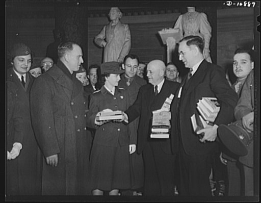 Victory Book Campaign. Mrs. Donald Buckingham, volunteer Red Cross member of Washington, D.C., receives victory books from Speaker of the House Samuel Rayburn and Representative John McCormick of Massachusetts