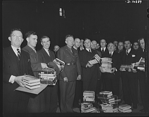 Victory Book Campaign. Vice-President Henry A. Wallace and members of Congress donate books to the armed forces for the 1942 Victory Book Campaign. Holding books are (left to right): Sergeant Dale Isley of Fort Myer, Virginia; Mr. Wallace; Senator Alben Barkley of Kentucky; and Representative Adolph