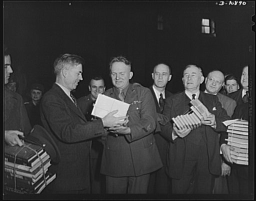 Victory Book Campaign. Vice-President Henry A. Wallace donating victory books to Corporal Frank York of Fort Myer, Virginia while Senator Lister Hill of Alabama looks on in ceremonies in Statuary Hall at the Capitol