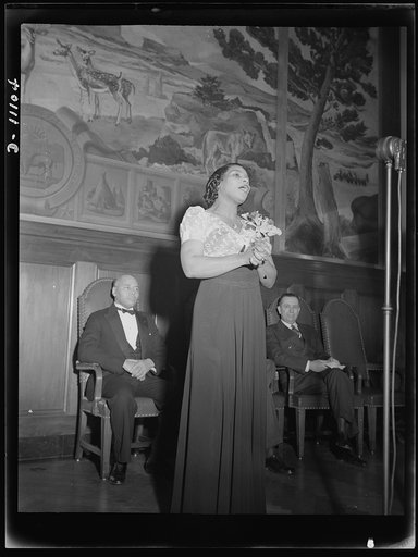 Washington, D.C. Marian Anderson broadcasting a Negro spiritual at the dedication of a mural installed in the United States Department of the Interior building, commemorating the outdoor concert which she gave at the Lincoln Memorial after the Daughters of Revolution refused to allow her to sing in 