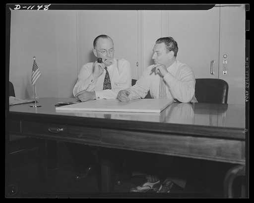Donald M. Nelson (left), Chairman, War Production Board (WPB), and Leon Henderson, Administrator, Office of Price Administration (OPA) and Director, Civilian Supply Division of the Office of Production Management (OPM), member of the Supply Priorities and Allocations Board; conferring in Washington,