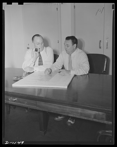 Donald M. Nelson (left), Chairman, War Production Board (WPB), and Leon Henderson, Administrator, Office of Price Administration (OPA) and Director, Civilian Supply Division of the Office of Production Management (OPM), member of the Supply Priorities and Allocations Board; conferring in Washington,