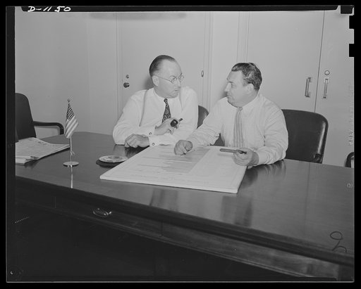 Donald M. Nelson (left), Chairman, War Production Board (WPB), and Leon Henderson, Administrator, Office of Price Administration (OPA) and Director, Civilian Supply Division of the Office of Production Management (OPM), member of the Supply Priorities and Allocations Board; conferring in Washington,