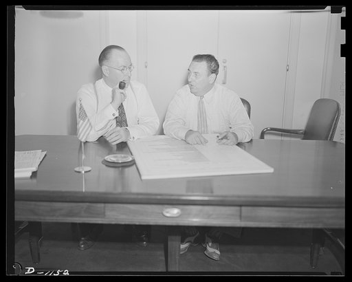 Donald M. Nelson (left), Chairman, War Production Board (WPB), and Leon Henderson, Administrator, Office of Price Administration (OPA) and Director, Civilian Supply Division of the Office of Production Management (OPM), member of the Supply Priorities and Allocations Board; conferring in Washington,