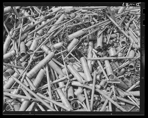 Steel manufacture, Allegheny-Ludlum. It's the end of a short episode for this scrap steel accumulated from the croppings of tubing and piping right in the steel mill. This scrap will be charged into steel converters once again, and again will emerge as refined steel for industrial production. Steel 