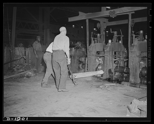 Steel manufacture, Allegheny-Ludlum. Here is a billet of alloy steel entering a mill in which it will be converted into the desired shape. It will emerge as a bar, perhaps round, perhaps square, and will eventually find its way into one of thousands of uses to which steel is put in our defense produ