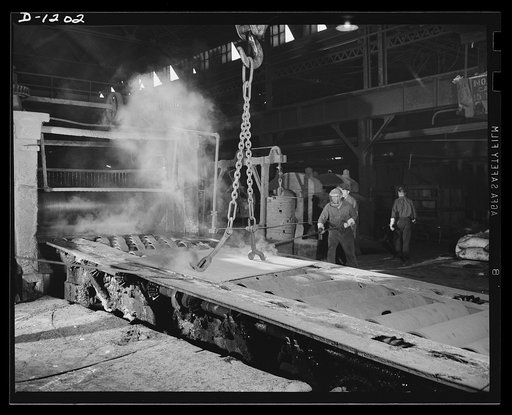 Steel manufacture, Allegheny-Ludlum. A slab of stainless is about to enter a three-high 110 inch plate mill, just having been removed from a heating furnace. This mill will roll the slab to produce the finish, thickness, width and length required for its use as tank armor