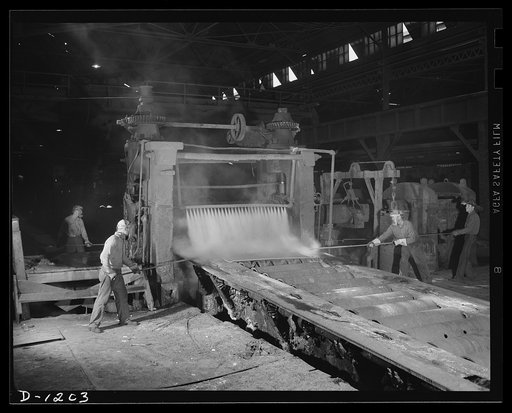 Steel manufacture, Allegheny-Ludlum. This slab of stainless steel is being rolled by a three-high 100 inch plate mill to bring it to the proper length, finish, thickness and width. It will eventually be used as tank armor