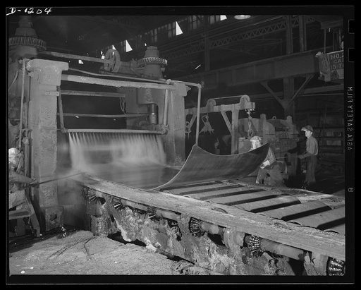 Steel manufacture, Allegheny-Ludlum. This slab of stainless steel is being rolled by a three-high 100 inch plate mill to bring it to the proper length, finish, thickness and width