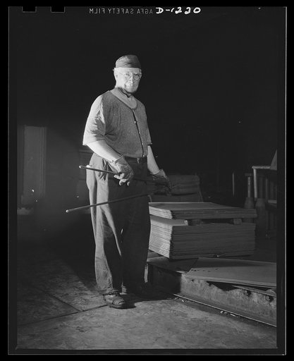 Steel manufacture, Allegheny-Ludlum. This sheet mill worker is charging sheets of steel into the heating furnace, from which they will emerge to be rolled into thin gauge sheets