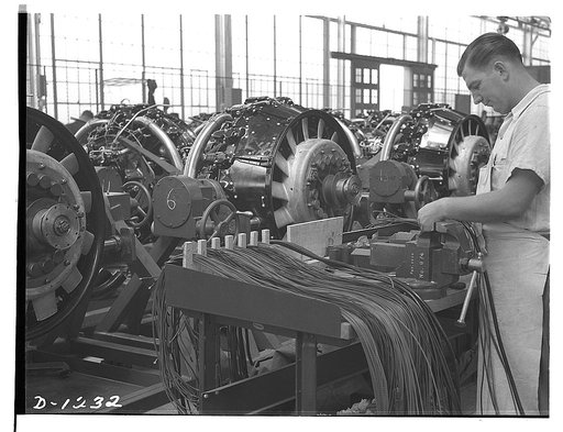 Tank manufacture (Chrysler). M-3s, the twenty-eight ton "medium" tanks being turned out in Detroit at the Chrysler tank arsenal, are powered by nine cylinder, 400 horsepower Wright Whirlwind aviation type engines. These men are working on the engine wiring sub-assembly