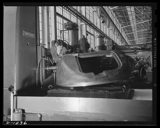 Tank manufacture (Chrysler). This turret casting for an M-3 tank weighs 4,000 pounds. The worker is completing one of the several milling operations necessary to insure perfect fit, for the gun which will fire from behind the turret must have freedom of movement. The tank itself, which might be term
