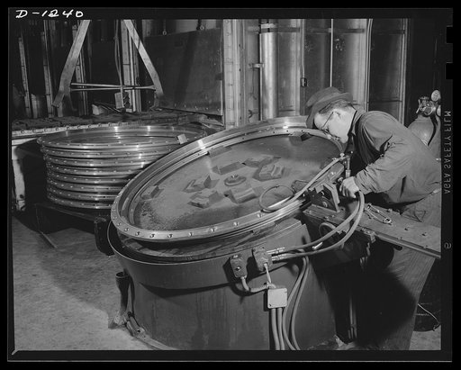 Tank manufacture (Chrysler). Turret rings for the Chrysler twenty-eight ton medium tanks are flame hardened. This skilled workers is one of the 10,000 producing M-3 tanks at the huge Chrysler tank arsenal in Detroit
