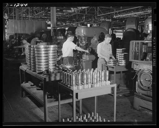 Tank manufacture (Chrysler). The worker in the foreground is inspecting herringbone gears for Chrysler twenty-eight ton medium tanks, just after they have been finished, or "shaved." All parts of these tanks undergo constant inspection after each of the various operations which eventually result in 