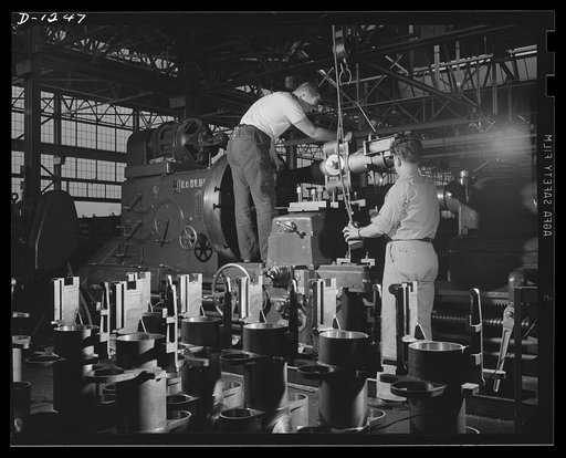 Tank manufacture (Chrysler). Efficient control of the 75 mm field guns with which M-3 tanks are equipped is assured by these careful workers. They are finishing the boring bronze bushing for the gun mount. They are only two of the 10,000 skilled workers turning out these twenty-eight ton land battle