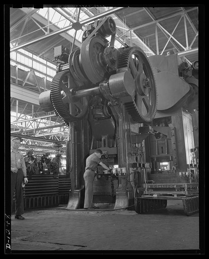Chrysler tank arsenal. This is one of the huge machine tools used in production of the M-3 tanks, the twenty-eight ton monsters built at the Chrysler tank arsenal in Detroit. This press works with a power of 450 tons, stamping out quarter inch steel floor plates