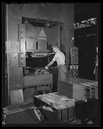Chrysler tank arsenal. This is one of the huge machine tools used in production of the M-3 tanks, the twenty-eight ton monsters built at the Chrysler tank arsenal in Detroit. This press works with a power of 450 tons, stamping out quarter inch steel floor plates