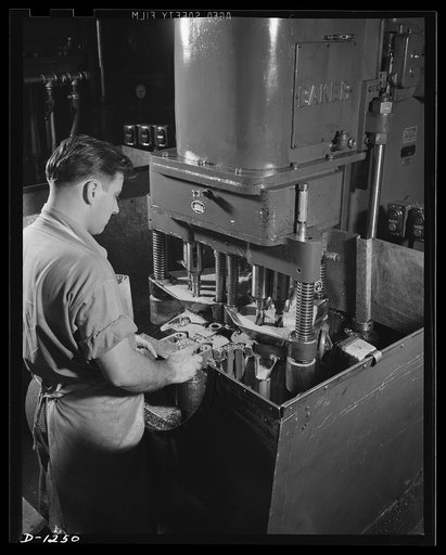 Tank manufacture (Chrysler). This worker is operating an eight-inch spindle machine designed for drilling and finish reaming of the show track and plates of an M-3 tank. Hundreds of specially designed machine tools are used in production of these twenty-eight ton steel giants, at the huge Chrysler t