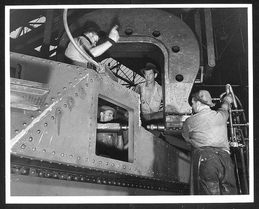 Chrysler tank arsenal. Thousands of rivets are used in the production of one of the huge thirty-eight ton M-3 tanks. Whenever possible rivets are replaced by welded sections, but throughout much of the tank, as in the side plates on which this riveter is working, the steel plate is too heavy for wel