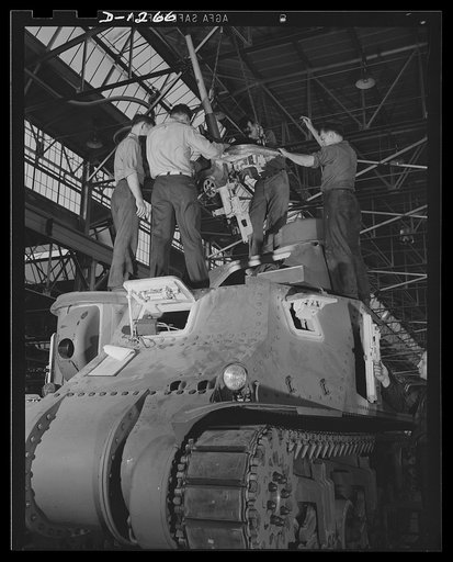 Chrysler tank arsenal. The firepower is inserted into the upper turret of an M-3 tank. These workers are installing an assembled 37 mm. anti-aircraft gun, which will then be protected by armor plate. Although this gun is designed for anti-aircraft use, it may also be used for straightway firing