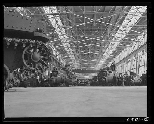Tank manufacture (Chrysler). These are partially completed M-3 tanks, twenty-eight ton steel giants being turned out at the huge Chrysler tank arsenal in Detroit. The camera was directed toward the end of the three main assembly lines. Mass assembly methods developed in automobile manufacture are us