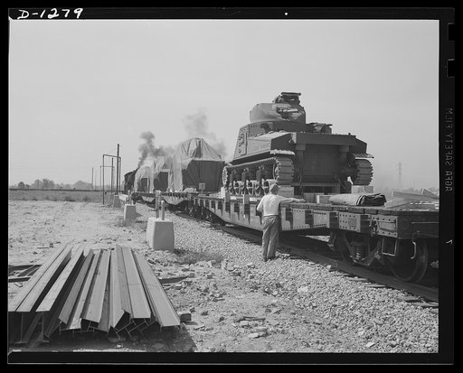 Chrysler tank arsenal. A trainload of complete M-3 tanks roll away from the huge Detroit Chrysler tank arsenal, to be delivered to the Army. Each of these tanks weigh over twenty-eight tons. The camera shows only the rear of the tank in the foreground. Note the 150 calibre machine gun. Three other m