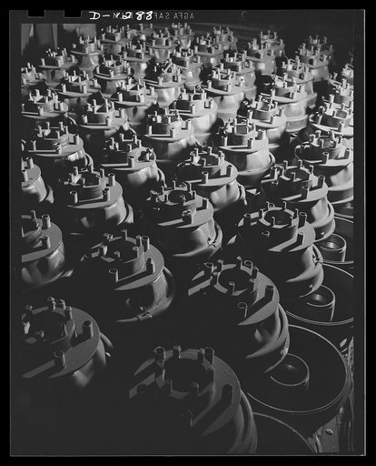 Army truck manufacture (Dodge). Row upon row of wheel hubs and brake drums for Army trucks tower skyward in huge piles at the Dodge company's great truck plant in Detroit