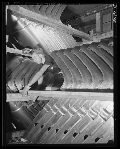 Army truck manufacture (Dodge). Lines of sheet metal formed into top and back panels for the cabs of Army trucks arrive at the truck plant daily in huge shipments loaded compactly into railroad freight cars. Four carloads are required for an average day's production