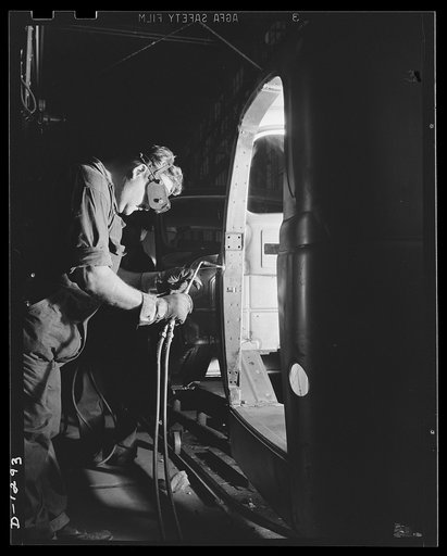 Army truck manufacture (Dodge). Skilled workers with blazing acetylene torches perform many exacting individual welding jobs in the production of cabs for Army trucks. Here a gas welder is working on what is known as the "A" post of an army truck cab
