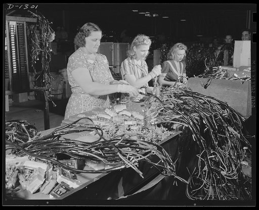 Army truck manufacture (Dodge). Working with a maze of wires and sensitive apparatus, these girls assemble the electrical instruments such as gas gauges, oil gauges, light switches, and so forth, to what is known as the wire "harness" for Dodge Army trucks