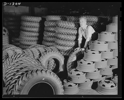Army truck manufacture (Dodge). A bank of wheels and tires for Dodge Army trucks piled up as they arrive at the plant before the assembling process starts