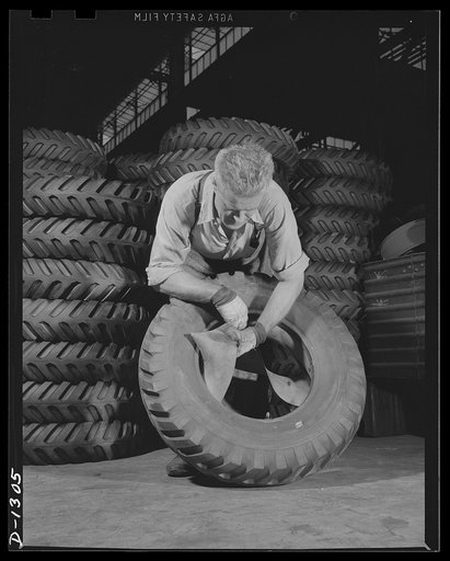 Army truck manufacture (Dodge). First operation in the process of tire and wheel assembly. The workman shown above is putting the tube and flap inside the casing of the type of tire with which all Dodge Army trucks are equipped