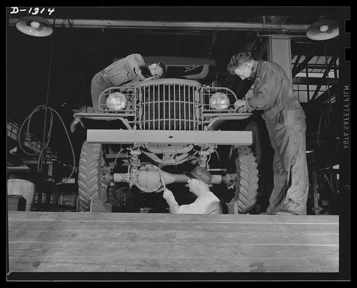 Army truck manufacture (Dodge). Crews of men operating in pits beneath the assembly line and at floor level carefully check, inspect and adjust virtually every nut and bolt of a Dodge Army truck as it is about to leave the assembly line and be turned over to U.S. Army inspectors