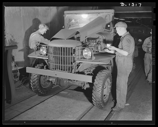 Army truck manufacture (Dodge). "Touch-up" men with brushes and spray guns putting the final touches of paint on each Dodge Army truck as it is about to be driven off the assembly line