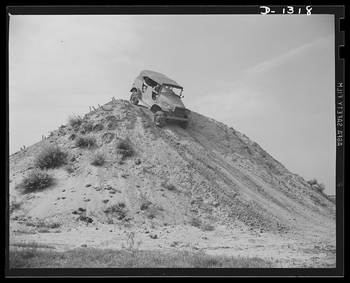 Army truck manufacture (Dodge). Over the top. An Army reconnaissance car which had just climbed a tremendously steep grade on the other side of this hill is here starting its descent down the equally steep grade visible in the picture. Going up and down this hill is a severe test for both driver and