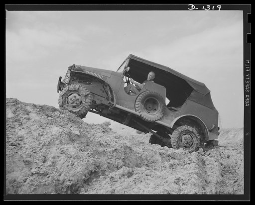 Army truck manufacture (Dodge). Army trucks must be capable of getting through, even in the worst possible operating conditions. Above is shown a Dodge Army truck climbing a tremendously steep grade over soft ground that gives the poorest kind of traction