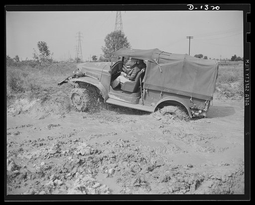 Army truck manufacture (Dodge). Army officers attending the school conducted by the Chrysler Corporation to assist our fighting forces in the job training men to operate the thousands of trucks required by today's streamlined division are given actual practice in driving the trucks in a testing fiel