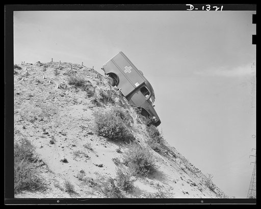 Army truck manufacture (Dodge). Here an army ambulance takes a nose dive down the almost perpendicular side of a high and tremendously steep hill which has been erected for the purpose of testing army vehicles