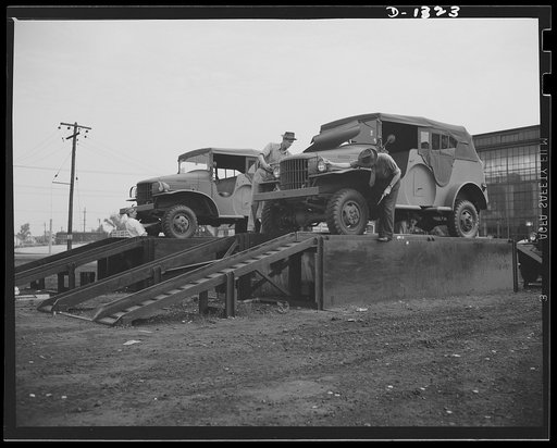Army truck manufacture (Dodge). Before Dodge Army trucks are shipped or driven to the various army posts throughout the country where they will be put service, U.S. government inspectors, as shown above, check each unit thoroughly before it goes into the yard