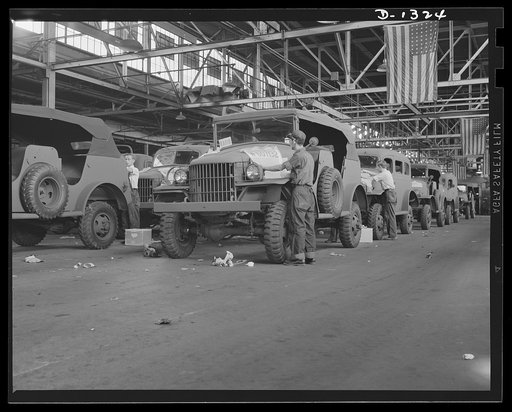 Army truck manufacture (Dodge). Each Dodge truck that goes into the service of the U.S. Army bears the government serial number stenciled on the hood. In the above picture, men working on the two production lines are putting the stencils in place