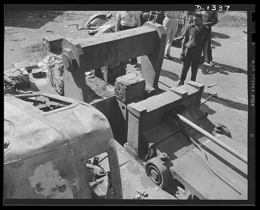Jalopies for defense. It doesn't look like much, but actually it's 300 pounds of scrap metal. Only a few minutes before it was thrown into the powerful hydraulic baling press it was the body of a discarded automobile. It is now ready for shipment to a steel mill. More than 28,000,000 tons of scrap m