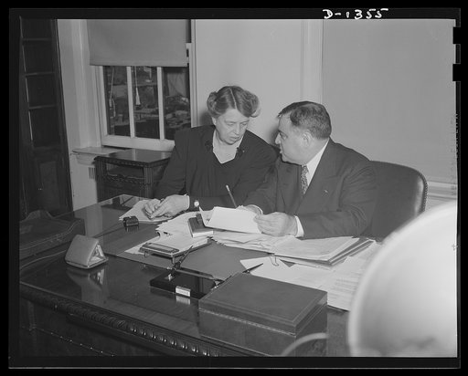 Mrs. Eleanor Roosevelt and Mayor Fiorello H. La Guardia in the latter's office in Washington on the occasion of Mrs. Roosevelt's being sworn in as Mayor La Guardia's assistant in the Office of Civilian Defense. Mrs. Roosevelt's title is Assistant Director of the Office of Civilian Defense. The cerem