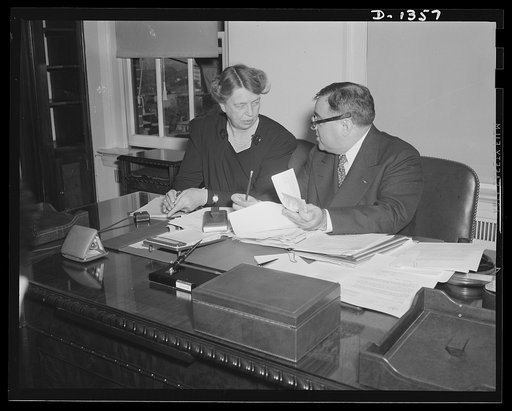 Mrs. Eleanor Roosevelt and Mayor Fiorello H. La Guardia in the latter's office in Washington on the occasion of Mrs. Roosevelt's being sworn in as Mayor La Guardia's assistant in the Office of Civilian Defense. Mrs. Roosevelt's title is Assistant Director of the Office of Civilian Defense. The cerem