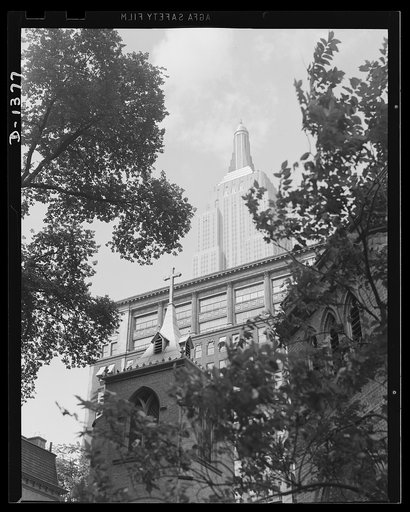 The four freedoms. Bold against the sky stands New York's Empire State Building, symbol of the genius and energy of the builders of America. The view is from the Little Church Around the Corner