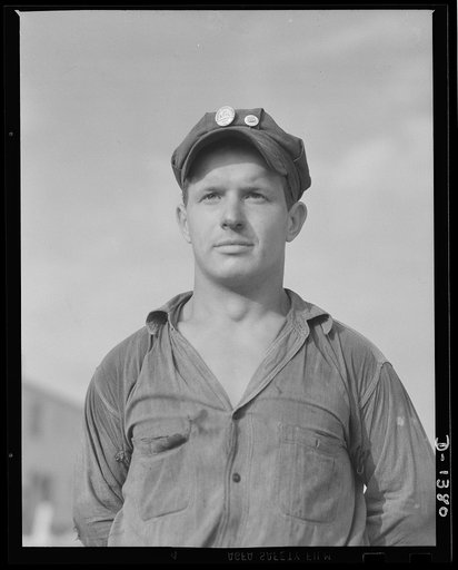 A defense worker takes the time out for the cameraman. He's a road construction worker at a vast defense housing project, which will provide homes for thousands of defense workers in Erie, Pennsylvania