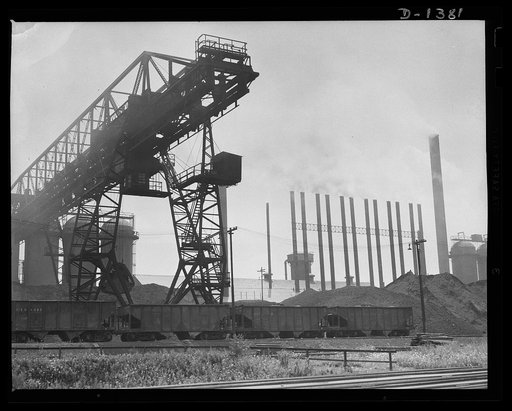 To harness the earth for the defense of democracy these chimneys, at an Etna, Pennsylvania, steel mill are belching forth smoke twenty-four hours a day. American steel mills have pushed production up to the very limit of their capacity