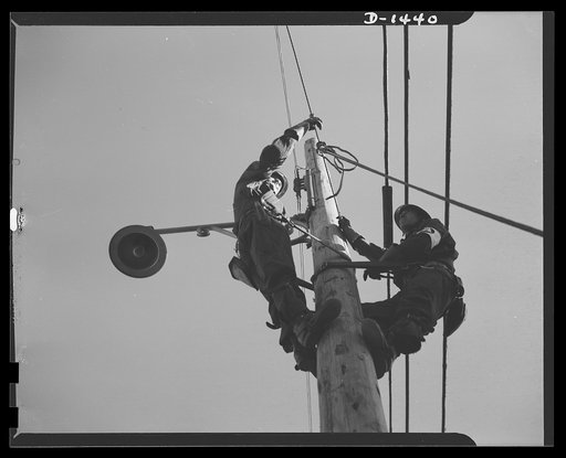 Civilian protection. Members of the public utility repair squads quickly replace a wire broken by falling fragments from an anti-aircraft raid