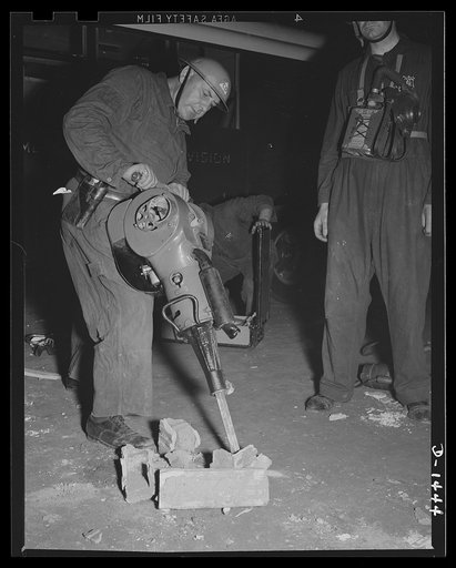 Civilian defense. A police emergency worker shows how Warsop asoline rockbreaker works. The two-cycled engine delivers 2300 blows per minute, and can be used to break through walls to release trapped persons. The demonstration was at the civilian defense show at Madison Square Garden, New York