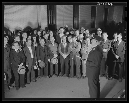 Civilian protection. Volunteer auxiliary firemen assemble in a New York firehouse and the battalion chief delivers a preliminary lecture on the scope and importance of their duties