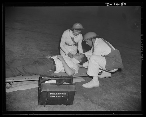 Civilian defense. Prompt medical attention is essential in civilian defense work. Here a disaster victim is receiving immediate emergency medical attention from a "castrophe team," which includes a doctor and a nurse